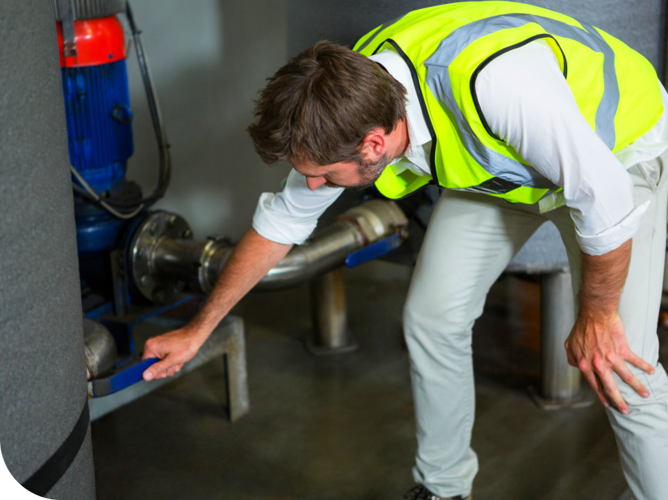 man wearing vest hand holding a tube