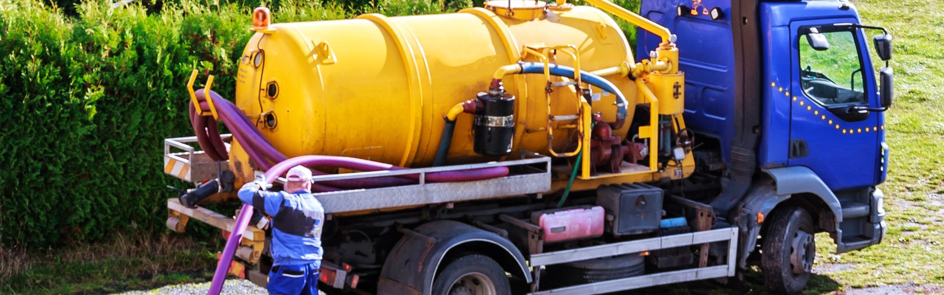 man holding pipe in front of truck