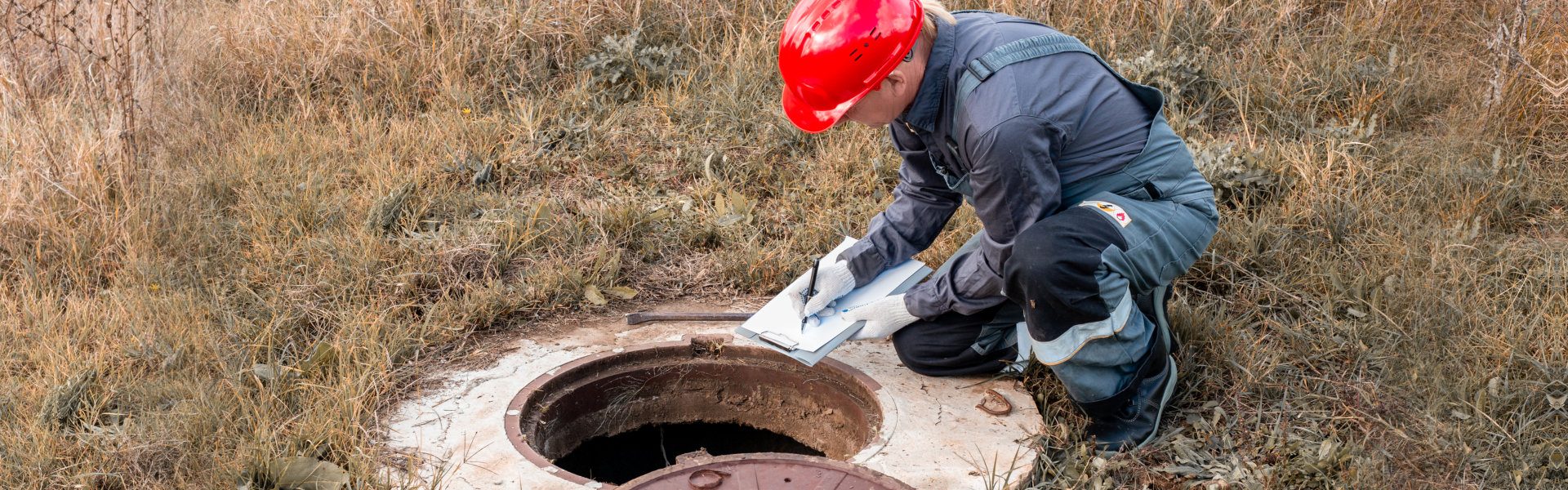 man in front of septic system